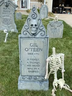 some tombstones with skeletons in the grass and one skeleton is laying on the ground