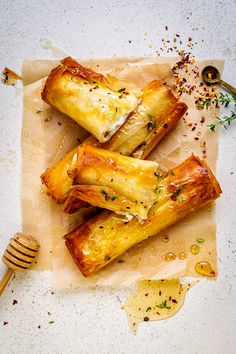 some food that is on top of a piece of parchment paper with a fork next to it