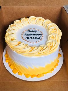 a birthday cake in a box with the words happy anniversary mom and dad written on it