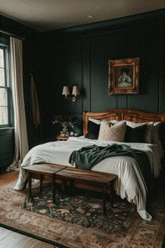 a bedroom with dark green walls and white bedding, wooden headboard, large windows, rugs on the floor