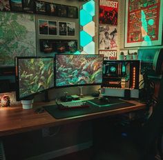 two computer monitors sitting on top of a wooden desk