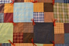 a patchwork quilt with red thread on it