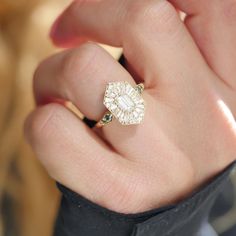 a person's hand with a ring on it