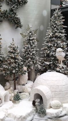 a display of fake snow covered trees and animals