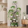 a living room filled with furniture and a tall plant on top of a stand in front of a flat screen tv