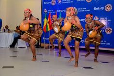 some women are dancing in front of a crowd