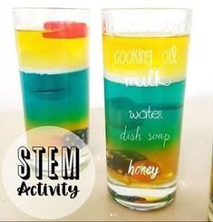 three glasses filled with different colored liquids on top of a table next to each other