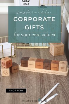 wooden cubes with the words corporate gifts for your core values on them, sitting in front of a desk