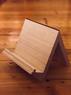 a wooden object sitting on top of a wooden floor