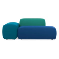 a blue and green couch sitting on top of a white floor next to each other