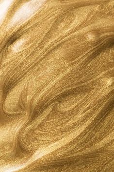 a close up view of some gold colored wood grainy material that is very shiny