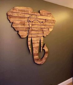 an elephant made out of wooden pallets on the wall