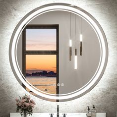 a bathroom with a large round mirror above the sink and two lights on the wall