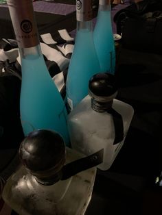 three bottles of wine sitting on top of an ice block