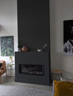 a living room filled with furniture and a fire place next to a painting on the wall