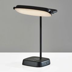 a black table lamp sitting on top of a white counter