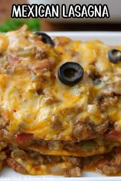 mexican lasagna stacked on top of each other with cheese and black olives