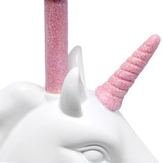 a white unicorn head with pink glitter on it