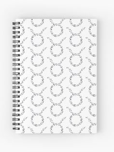 a spiral notebook with black and white circles on it