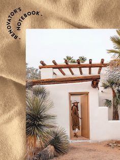 an adobe - style house with palm trees in the foreground and a doorway leading to it