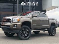 a silver truck parked in front of a building