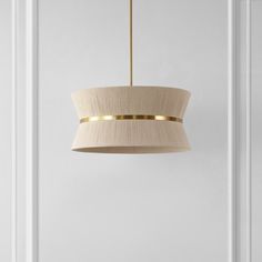 a light fixture hanging from the ceiling in a room with white walls and flooring