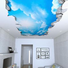 a living room with white walls and blue sky painted on the ceiling