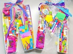 two plastic bags filled with different types of toothbrushes