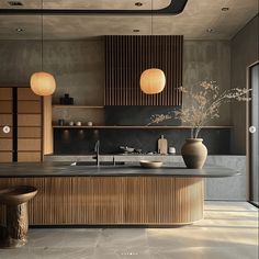 a large kitchen with wooden cabinets and marble counter tops, along with two vases on the island