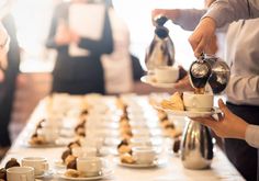 people serving food at a buffet table with coffee and pastries on the trays