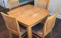 a wooden table and chairs in a room