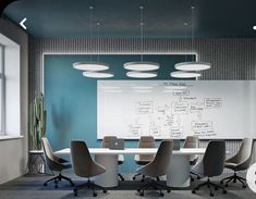 a conference room with chairs and a whiteboard on the wall in front of it