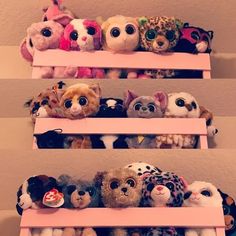 several shelves filled with stuffed animals on top of each other in front of a wall