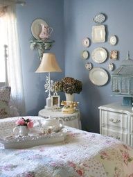 a bedroom with blue walls and white furniture