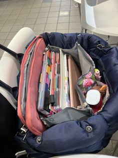 an open backpack sitting on top of a toilet