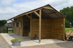 a small wooden shed with a metal roof