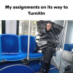 a man sitting on top of a blue bus seat covered in a black tarp