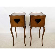 two wooden nightstands with hearts on them