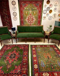 a living room filled with green couches and rugs on top of each other