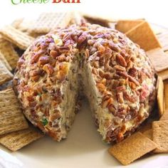 a close up of a cake on a plate with crackers and other food items