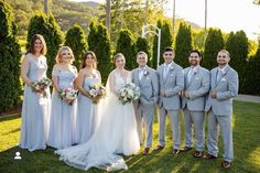 a group of people that are standing in the grass