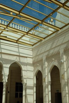 the inside of a building with arches and windows