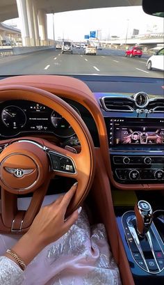 the interior of a car is shown with an orange leather steering wheel and dash board