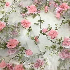 pink flowers on white fabric with green leaves