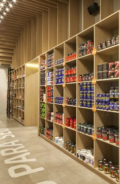 the shelves are filled with various types of cans and cans of food on display in an open area