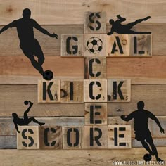 the silhouettes of soccer players are on wood blocks that spell out goal, kick, and score