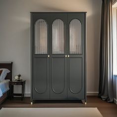 a room with a bed and two tall gray cabinets