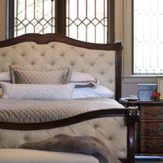 a bedroom with a large bed and chandelier