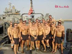 a group of men standing next to each other on top of a boat