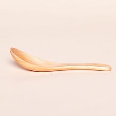 a wooden spoon sitting on top of a white table